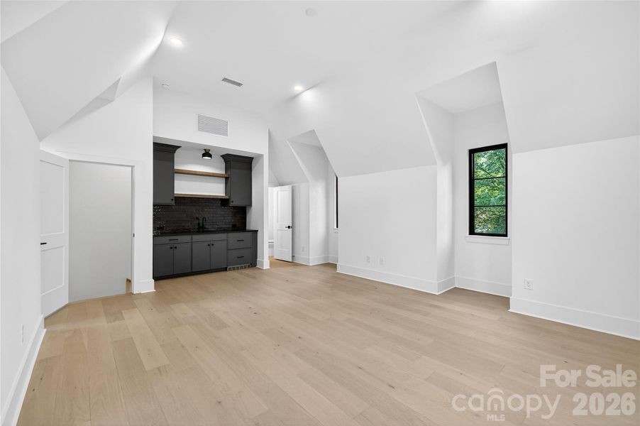 Finished entertainment space above garage