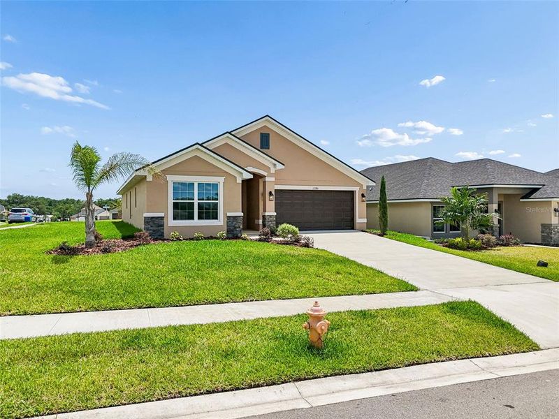 Front exterior of a new home in Abbey Glen, Dade City, FL, highlighting curb appeal (Image 30).