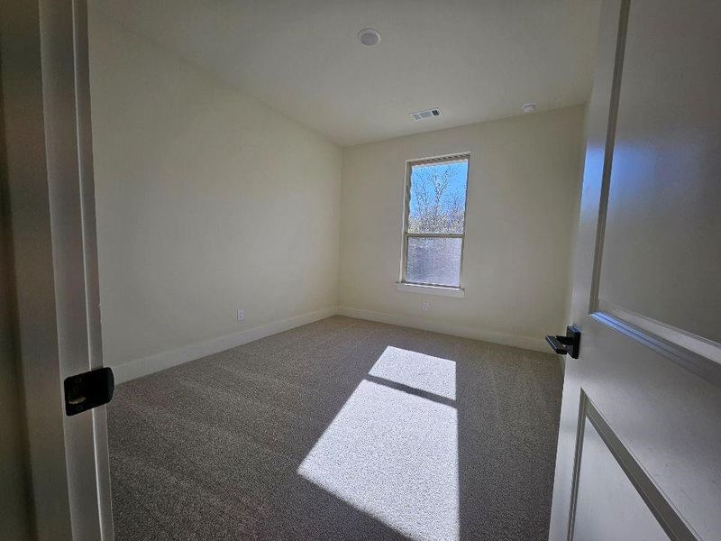 Carpeted empty room with baseboards