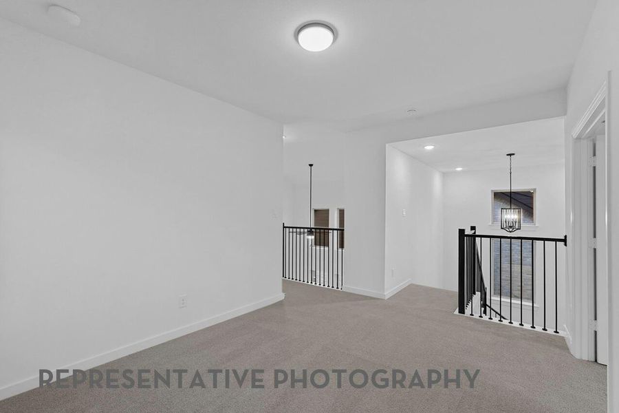 A versatile loft overlooks the family room below, offering an open, connected space ideal for relaxing or gathering.