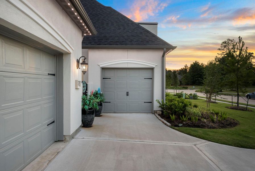 Spacious three-car garage with ample room for vehicles, storage, and hobbies.