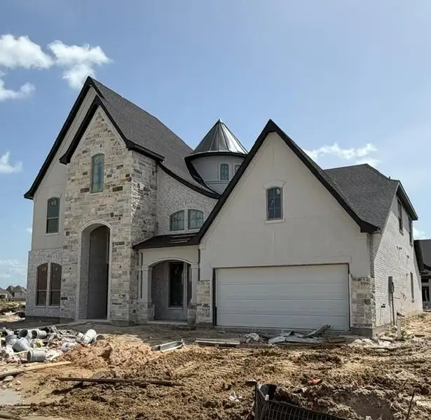 This beautiful front elevaton featrues a lovely combination of brick, natural stone, and stucco details. This beautiful front elevaton featrues a lovely combination of brick, natural stone, and stucco details.