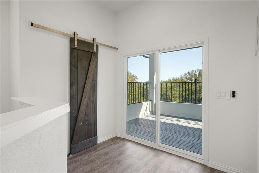 Entryway featuring wood-type flooring and a barn door