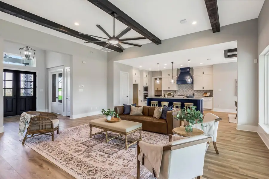 Spacious entryway seamlessly connects to an open kitchen, perfect for modern living.