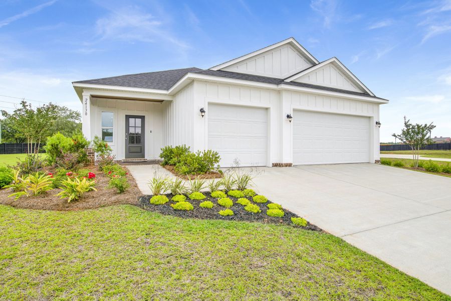 Front exterior of a new home in Coastal Communities, Edgewater, FL, highlighting curb appeal (Image 27).