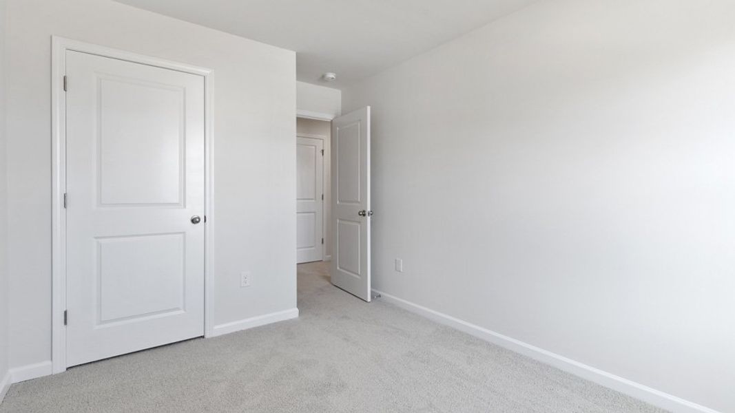 Spacious, unfurnished interior of a new home in The Townes at Bexford, Willow Spring (Image 13).