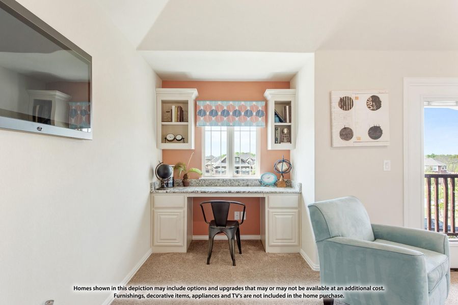 Built-in desk nook with white cabinets, granite countertop, and window set against a coral accent wall