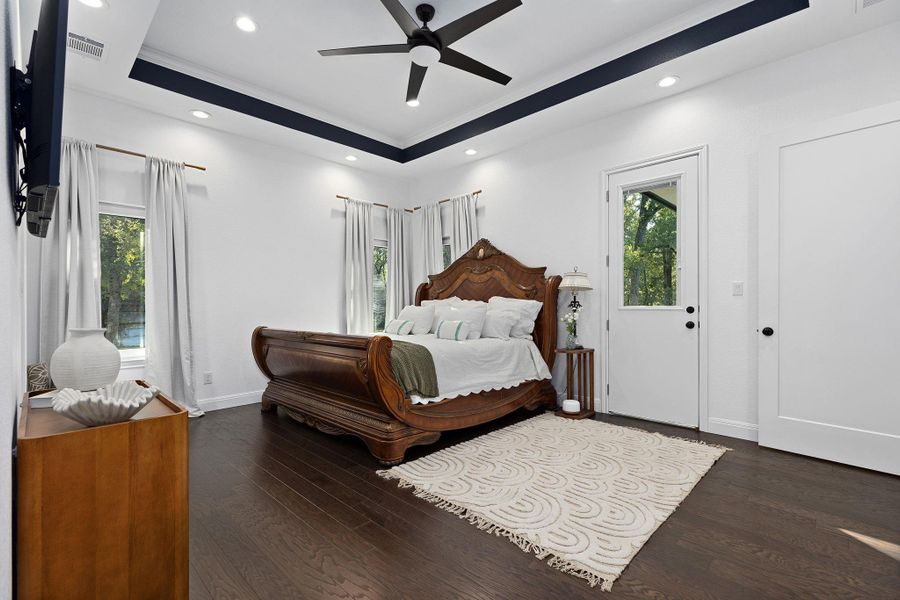 Bedroom featuring a raised ceiling, dark wood finished floors, recessed lighting, and ceiling fan Bedroom featuring a raised ceiling, dark wood finished floors, recessed lighting, and ceiling fan