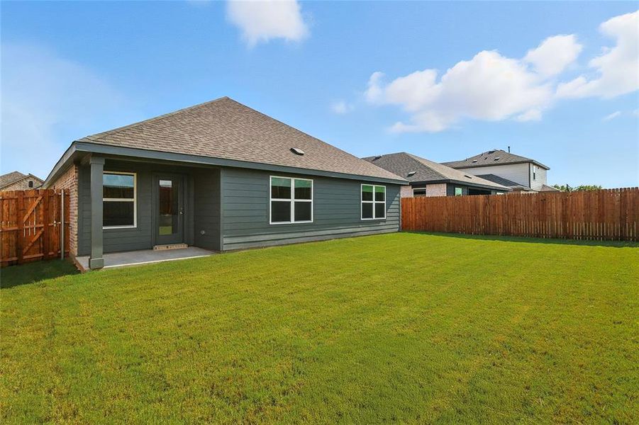 Rear view of property with a patio area, a fenced backyard, and a shingled roof Rear view of property with a patio area, a fenced backyard, and a shingled roof