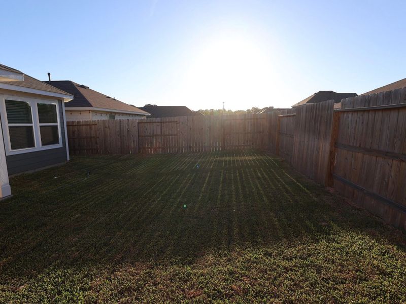 Exterior details and patio area of a home in Pinewood at Grand Texas, New Caney (Image 19).