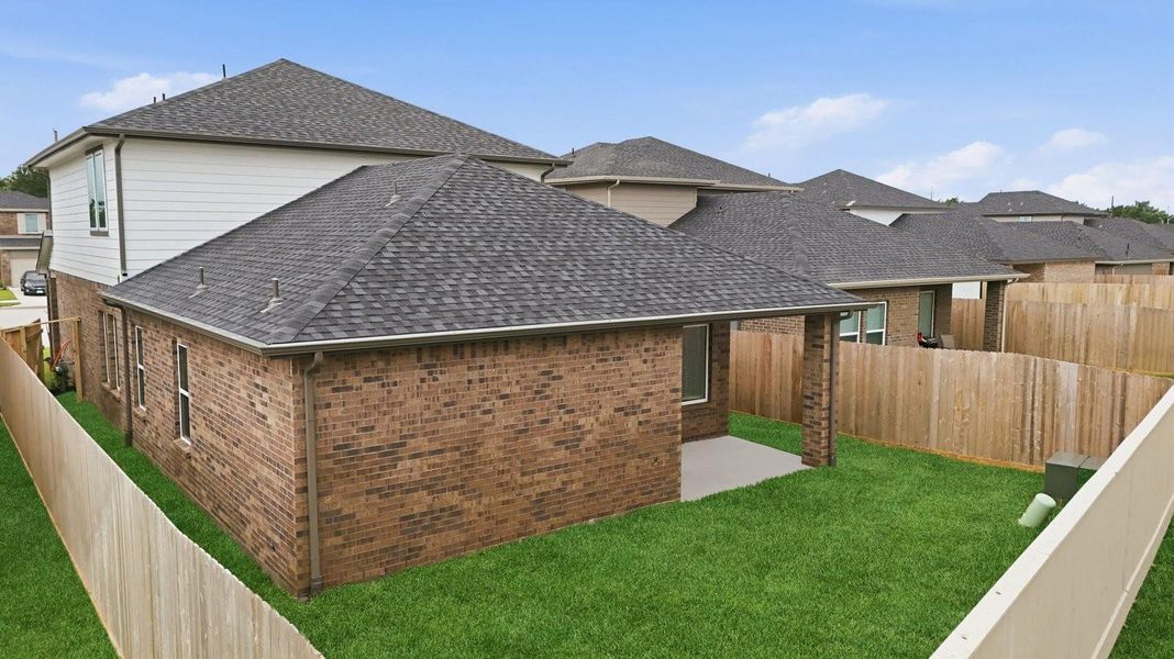 Outdoor covered patio with seating area overlooking a well-maintained lawn, perfect for relaxation. Outdoor covered patio with seating area overlooking a well-maintained lawn, perfect for relaxation.