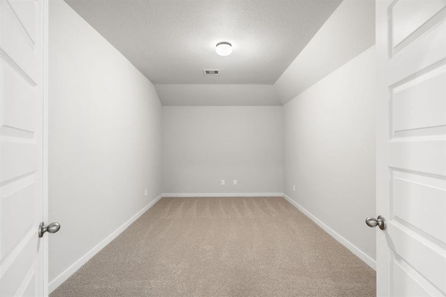 Enjoy gaming or movie nights in this spacious and dedicated theatre room. Sample photo of completed home with similar floor plan. As-built interior colors and selections may vary.