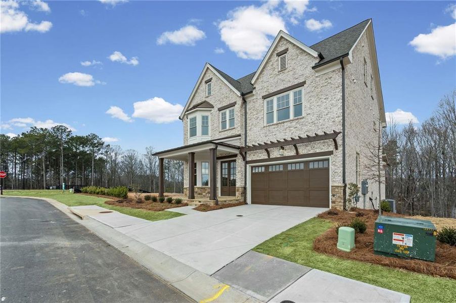 Front exterior of a new home in Laurel View, Suwanee, GA, highlighting curb appeal (Image 31). Front exterior of a new home in Laurel View, Suwanee, GA, highlighting curb appeal (Image 31).