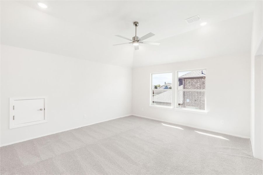 Empty bedroom with gray carpet, ceiling fan, white walls, and a double window Empty bedroom with gray carpet, ceiling fan, white walls, and a double window