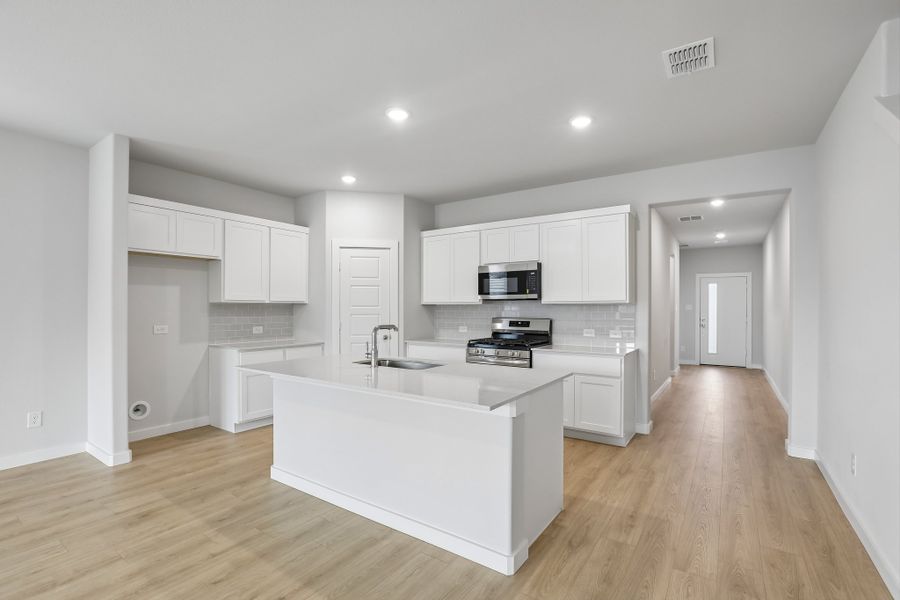Kitchen in the Holden home plan by Trophy Signature Homes