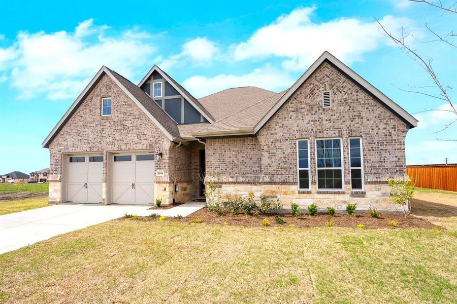 Front exterior of a new home in Polo Ridge, Mesquite, TX, highlighting curb appeal (Image 2). Front exterior of a new home in Polo Ridge, Mesquite, TX, highlighting curb appeal (Image 2).