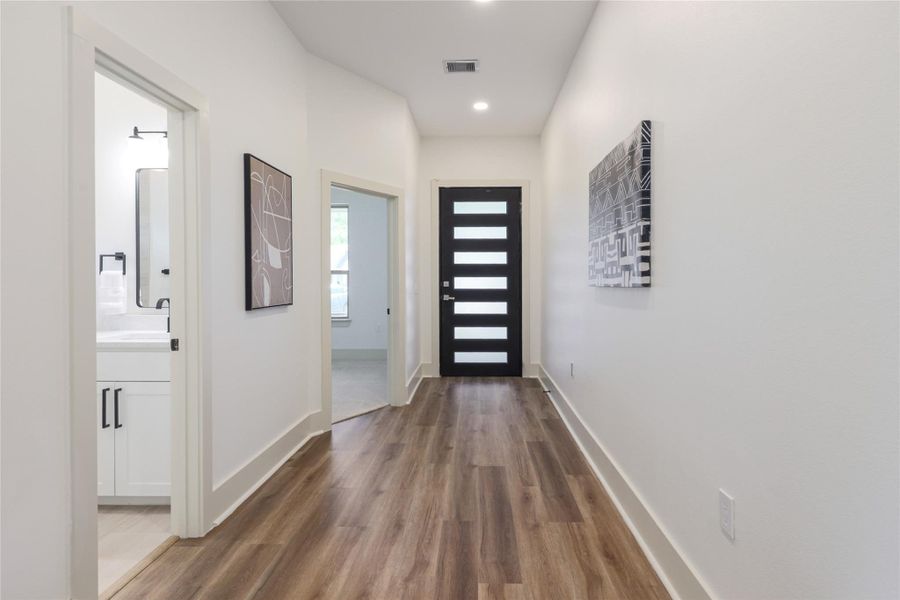 Doorway featuring wood finished floors and recessed lighting