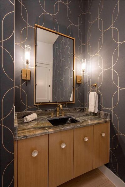 Bathroom featuring vanity and wood-type flooring