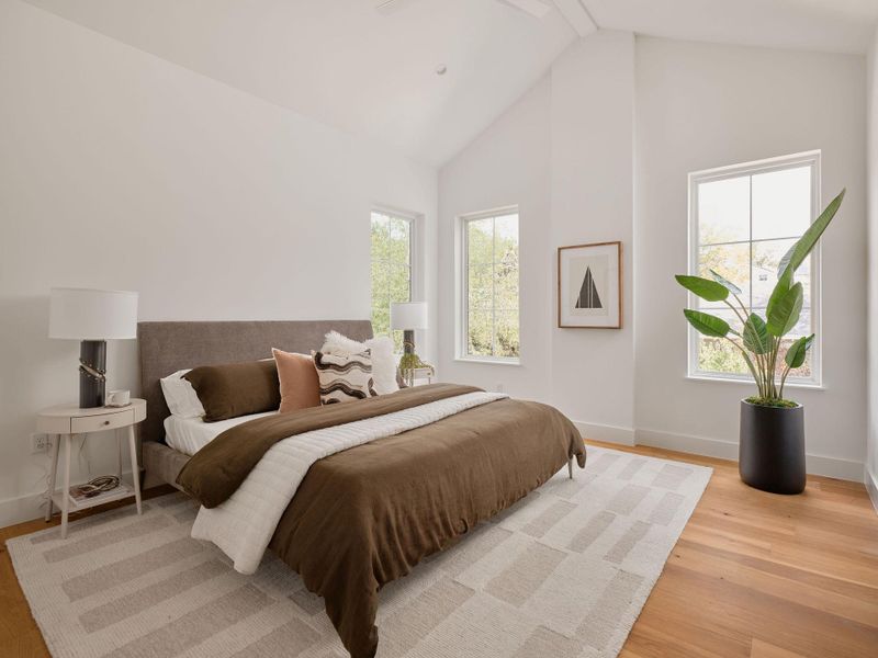 Bedroom with light wood-style floors, multiple windows, high vaulted ceiling, ceiling fan, and beam ceiling Bedroom with light wood-style floors, multiple windows, high vaulted ceiling, ceiling fan, and beam ceiling