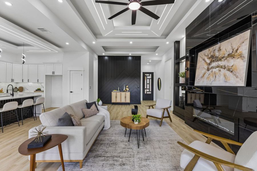 Gleaming hardwood floors and a modern linear fireplace anchor this open-concept main level.