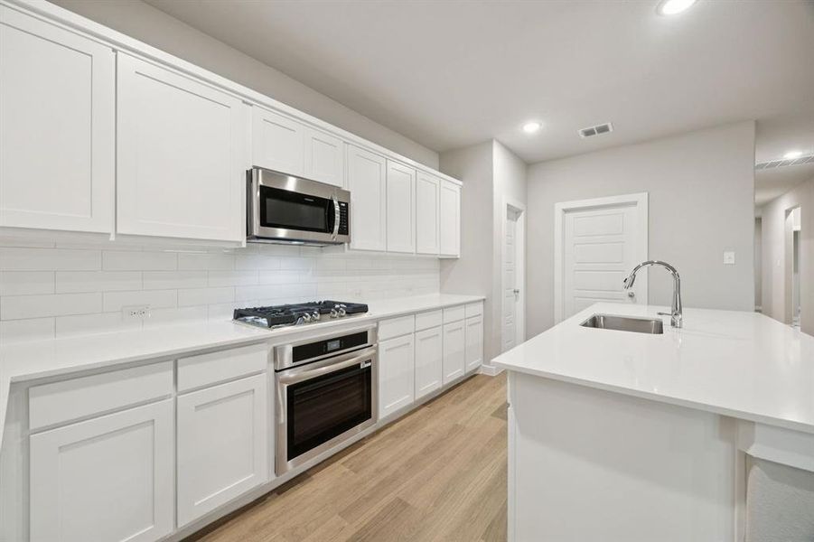Kitchen in the Oscar home plan by Trophy Signature Homes – REPRESENTATIVE PHOTO Kitchen in the Oscar home plan by Trophy Signature Homes – REPRESENTATIVE PHOTO