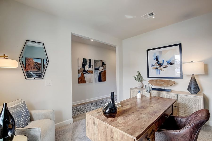 A living room with a table and chairs.