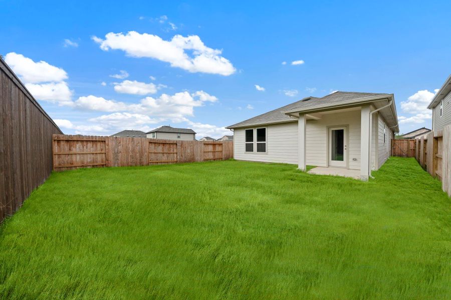 Step outside and enjoy the perfect blend of privacy and open space in this beautifully backyard.