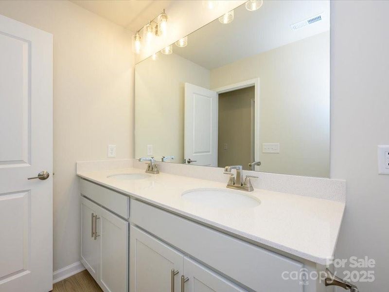 Dual vanity sinks at the secondary bath. Dual vanity sinks at the secondary bath.