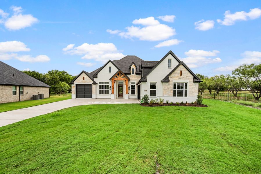 Front exterior of a new home in Rolling Creek Ranch, Aledo, TX, highlighting curb appeal (Image 1). Front exterior of a new home in Rolling Creek Ranch, Aledo, TX, highlighting curb appeal (Image 1).