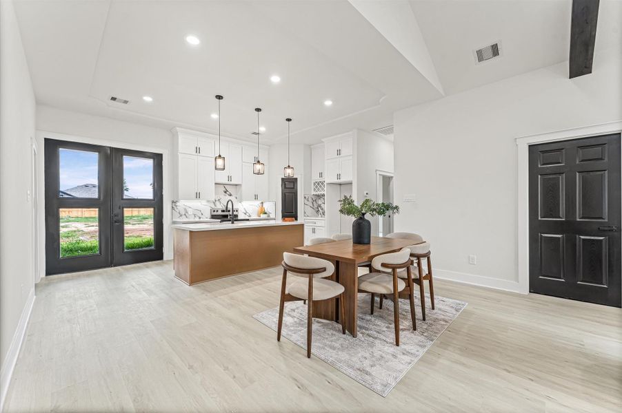 Spacious kitchen featuring abundant cabinetry, center island, and plenty of counter space for meal prep and gatherings. Photos are representative of the same floor plan built by this builder. Finishes will be the same or similar.