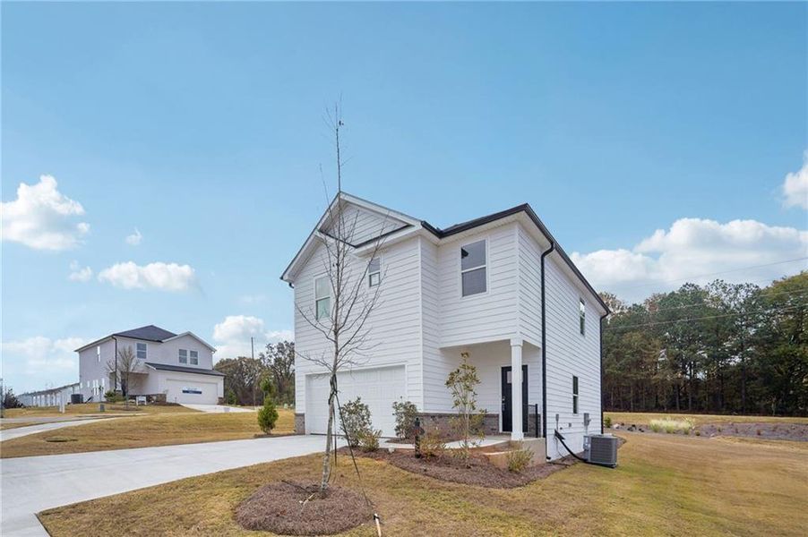 Front exterior of a new home in Avalon - Reserve Series, Conyers, GA, highlighting curb appeal (Image 1).