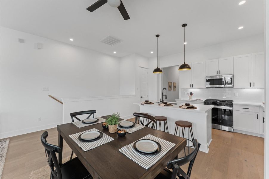 Elegant and inviting dining area designed for both everyday meals and special gatherings. The space features a well-proportioned layout that comfortably accommodates a full-size dining table, surrounded by stylish seating. Natural light filters in through nearby windows or glass doors, highlighting the room’s neutral palette and contemporary finishes.