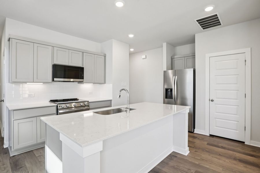 A kitchen with white cabinets. A kitchen with white cabinets.