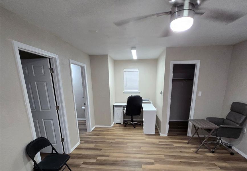 Office, guest bedroom, living room with light wood-type flooring and ceiling fan