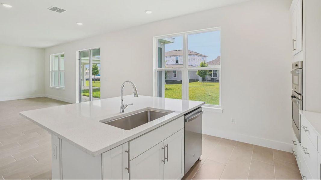 Plumeria Floor Plan featuring a bright kitchen with large island by DRB Homes in Trailside located in Mount Dora, FL Plumeria Floor Plan featuring a bright kitchen with large island by DRB Homes in Trailside located in Mount Dora, FL