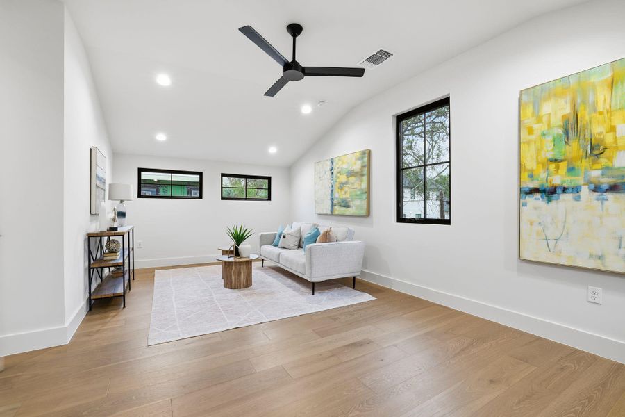 Living room featuring lofted ceiling, light wood-style floors, recessed lighting, and ceiling fan