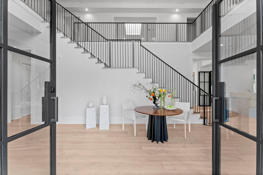 Through the wrought iron glass double doors, you are graced by white oak wide plank flooring Through the wrought iron glass double doors, you are graced by white oak wide plank flooring