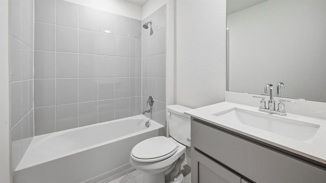 Bathroom with a white vanity featuring a rectangular sink, chrome faucet, and an integrated mirror
