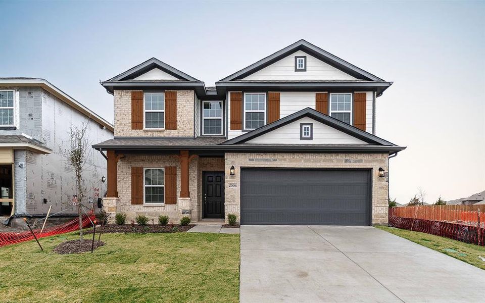 Front exterior of a new home in Travis Ranch, Forney, TX, highlighting curb appeal (Image 1). Front exterior of a new home in Travis Ranch, Forney, TX, highlighting curb appeal (Image 1).