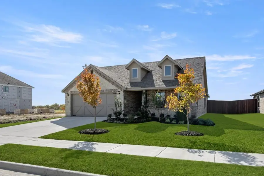 Front exterior of a new home in Myrtle Creek, Waxahachie, TX, highlighting curb appeal (Image 2). Front exterior of a new home in Myrtle Creek, Waxahachie, TX, highlighting curb appeal (Image 2).