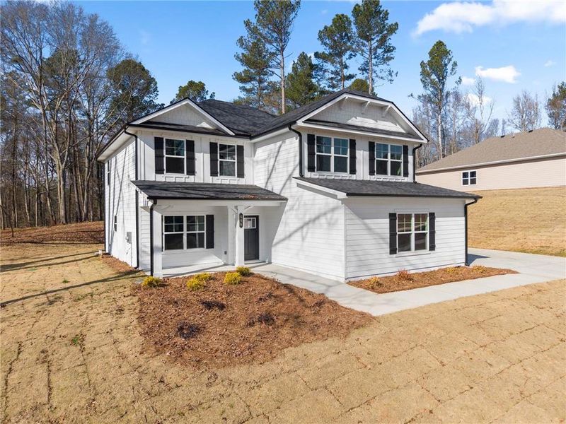 Front exterior of a new home in The Fields of Walnut Creek, Pendergrass, GA, highlighting curb appeal (Image 18).