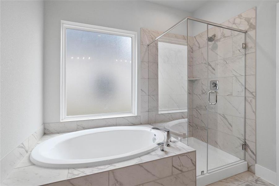 This primary bathroom also features a dark framed walk-in shower with tile surround, separate garden tub for soaking after a long day with custom tile detailing, high ceilings, custom paint, sleek and dark modern finishes!