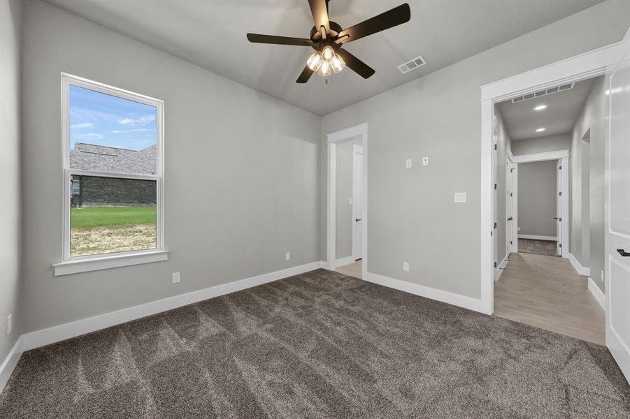 bedroom 2 with carpet flooring and ceiling fan