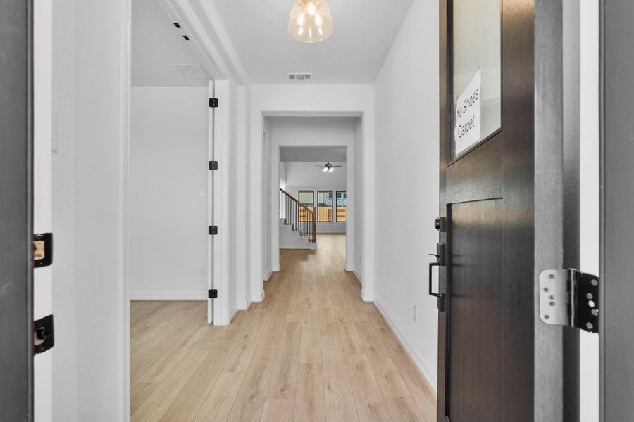 An elegant foyer sets a grand first impression with luminous surfaces and dramatic contrast.