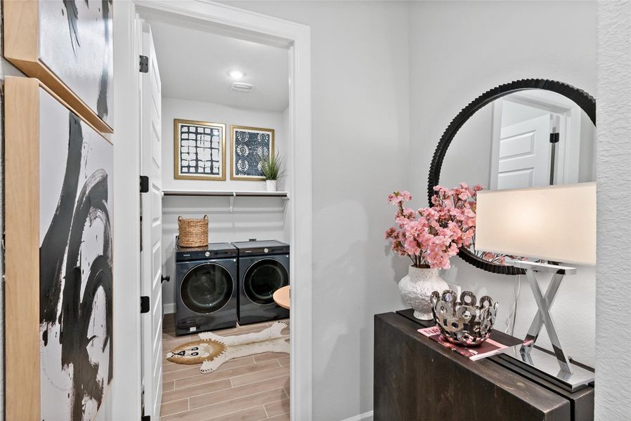 Washroom with washing machine and dryer and wood tiled floors