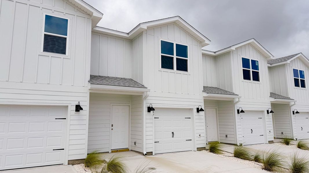 Front exterior of a new home in Salt Creek Townhomes at Mexico Beach, Mexico Beach, FL, highlighting curb appeal (Image 2). Front exterior of a new home in Salt Creek Townhomes at Mexico Beach, Mexico Beach, FL, highlighting curb appeal (Image 2).