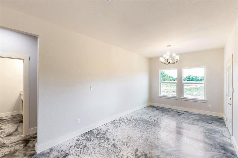 Unfurnished room with a notable chandelier