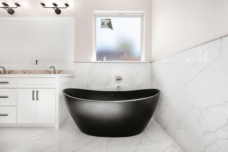 Bathroom with a bath, vanity, tile patterned floors, and tile walls