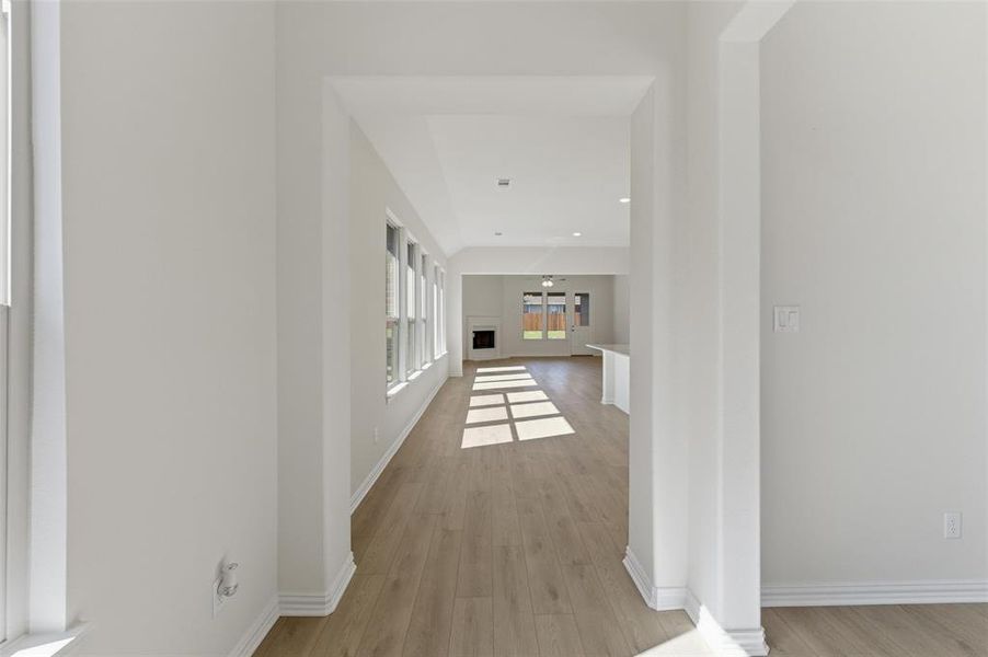 Hallway with light wood-style floors, recessed lighting, and french doors