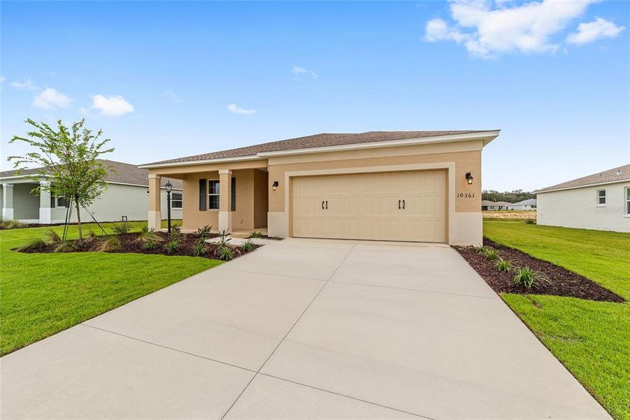 Front exterior of a new home in On Top of the World Communities, Ocala, FL, highlighting curb appeal (Image 25).